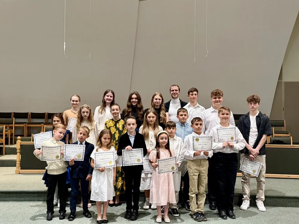 Students with their piano achievement certificates