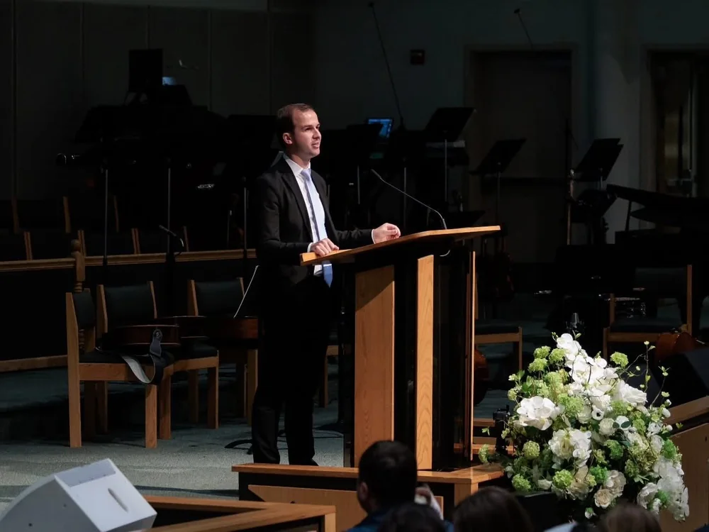 Oleksandr Savchenko speaking at a church service