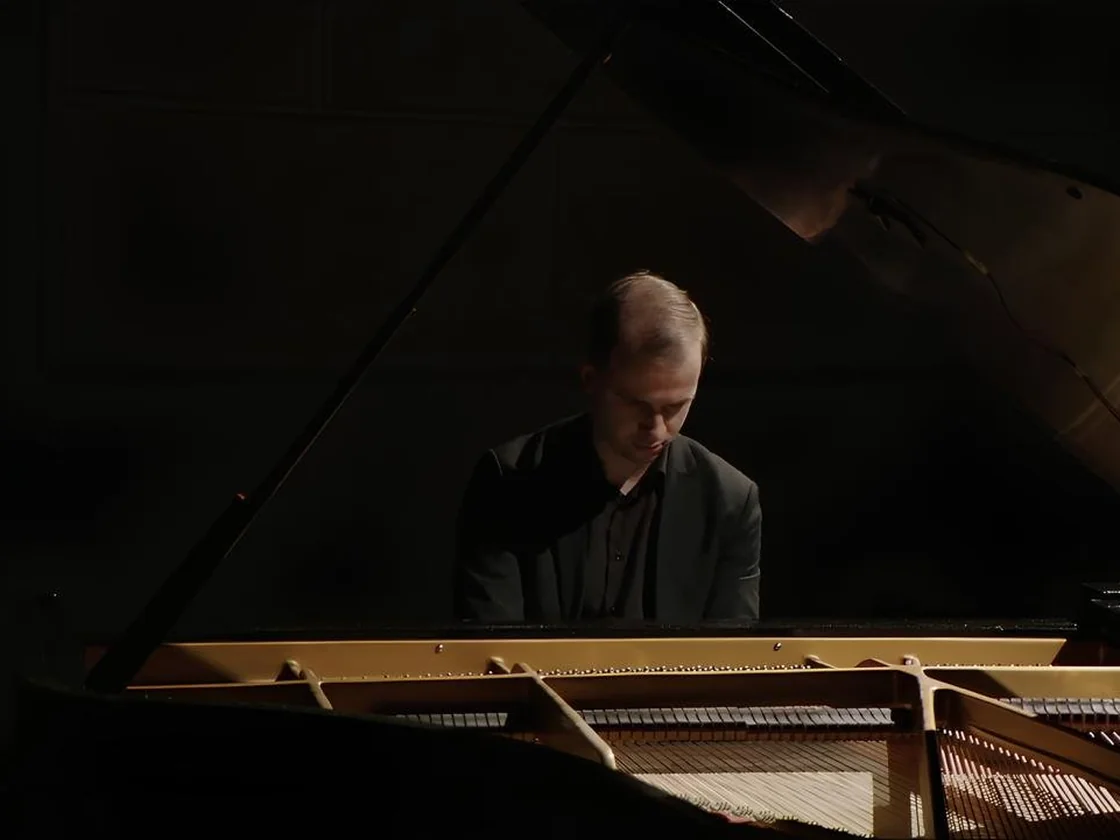 Students reading music at the piano